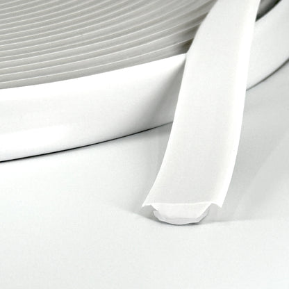 Close-up of white Smarter Trim roll with adhesive backing partially exposed.