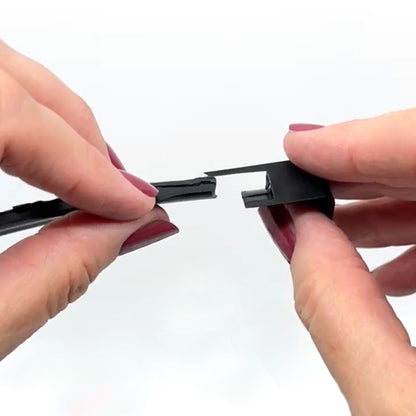 hands aligning smartertrim inside corner piece with trim channel for snap-fit installation”