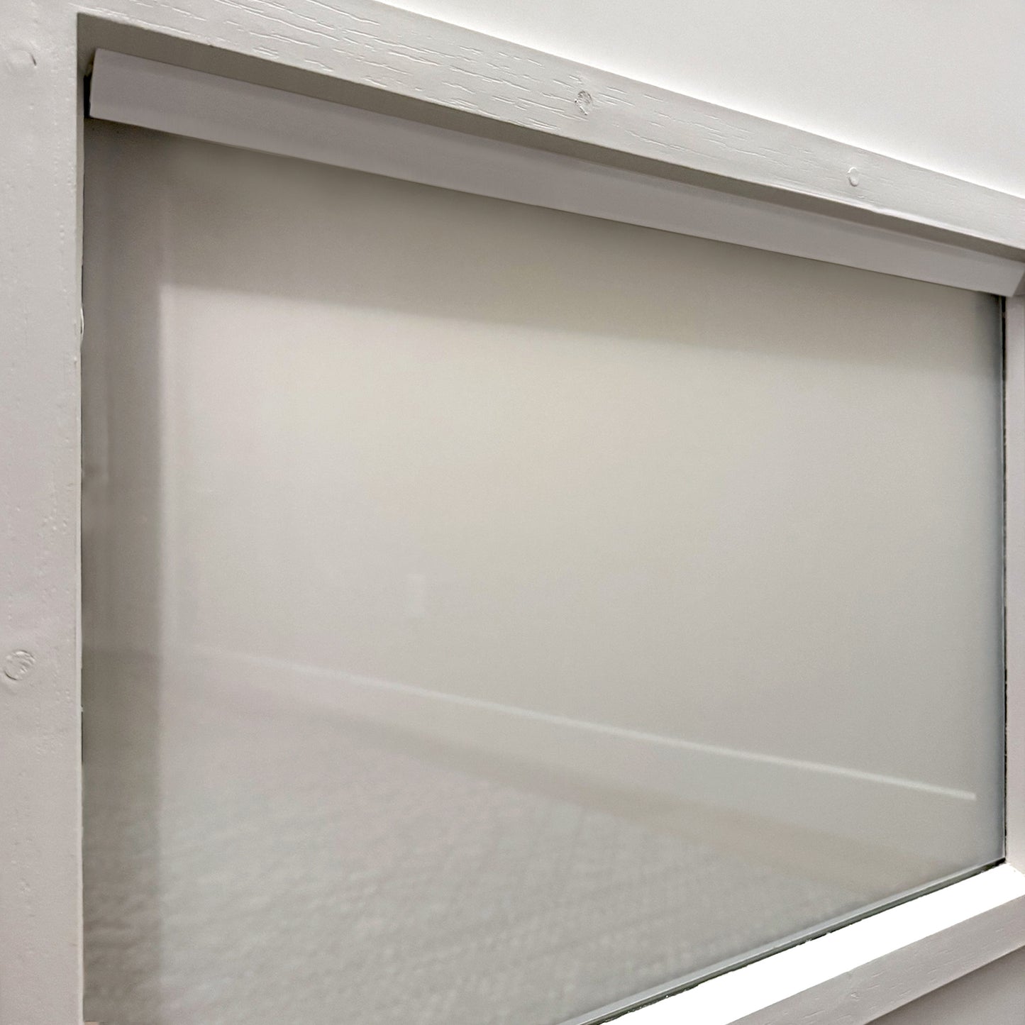 Window with Smarter Trim installed, creating a smooth, finished look over smart film edges.